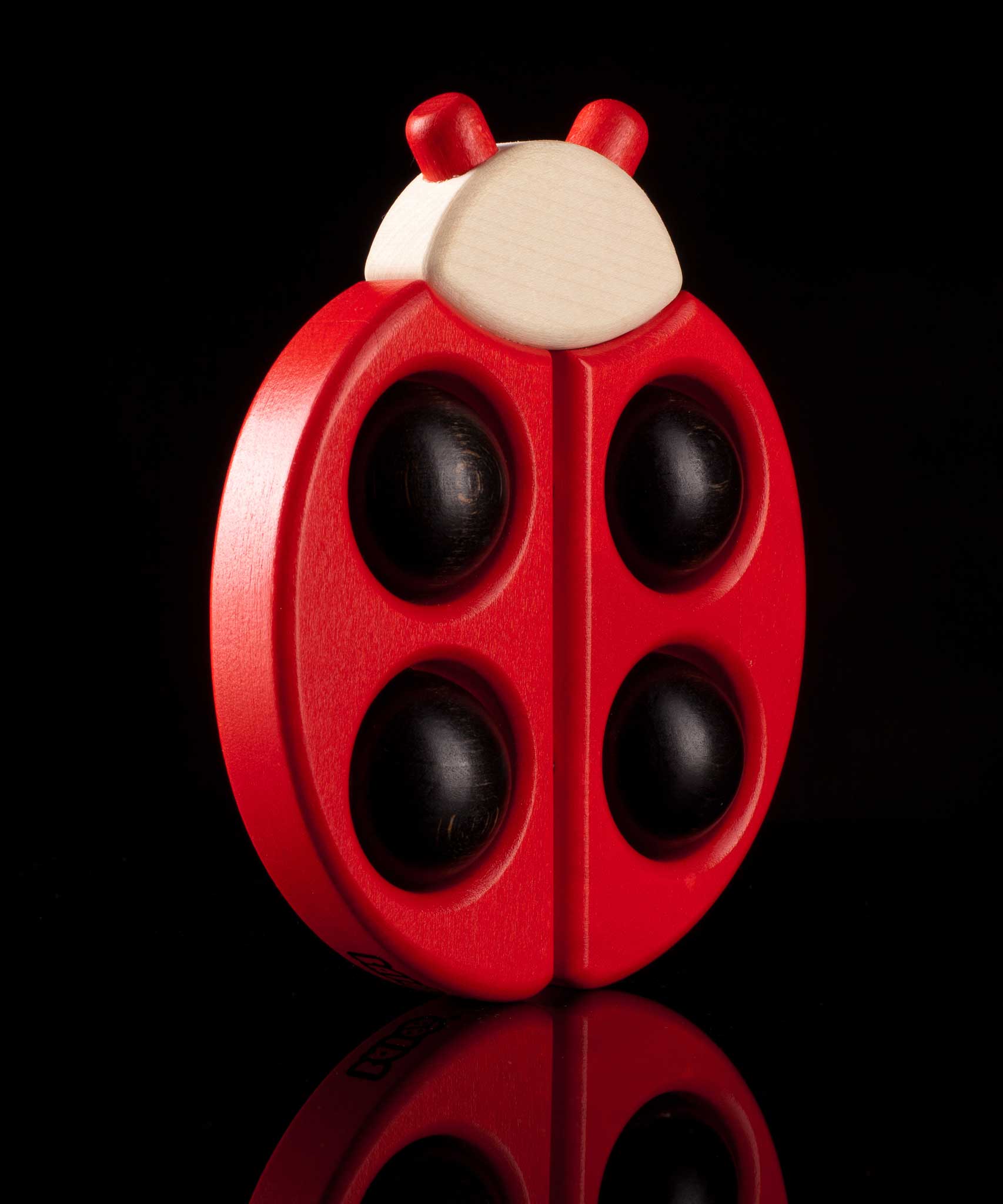 Bajo Red Ladybird Teether shown on a black background.