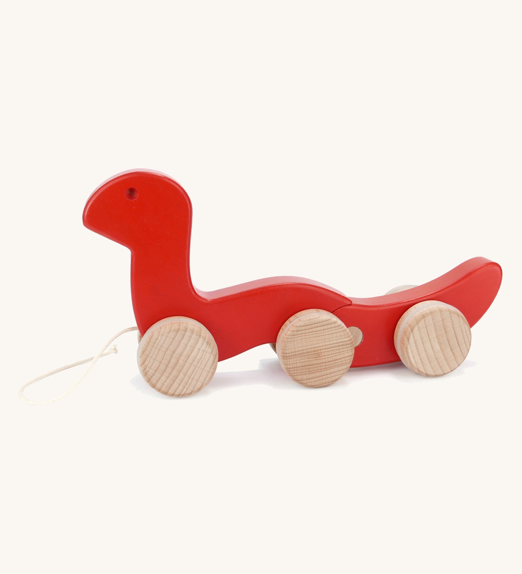 Bajo wooden red wriggly worm, available at Babipur. Body is in two parts that move up and down and features unpainted wooden wheels with a string on the front to pull along