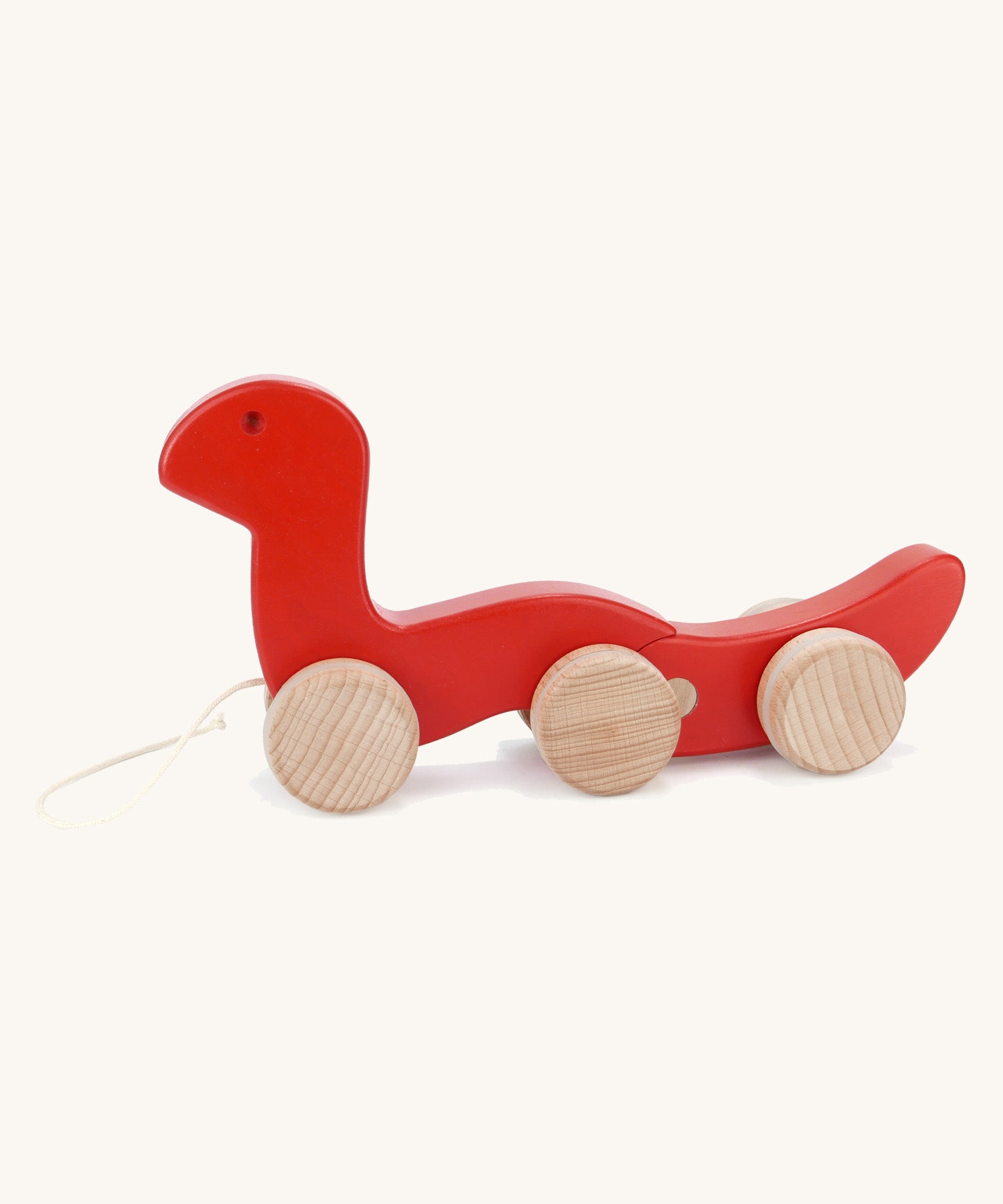 Bajo wooden red wriggly worm, available at Babipur. Body is in two parts that move up and down and features unpainted wooden wheels with a string on the front to pull along