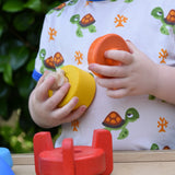 Child playing with teh Bajo stacking rocket wooden toy.