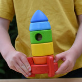 Bajo stacking rocket wooden toy in a child hands.
