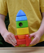 Bajo stacking rocket wooden toy in a child hands.
