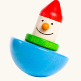 Bajo roly poly wobbling dwarf wooden baby toy. Blue half sphere base that wobbles when pushed with a wooden dwarf character on top from Babipur