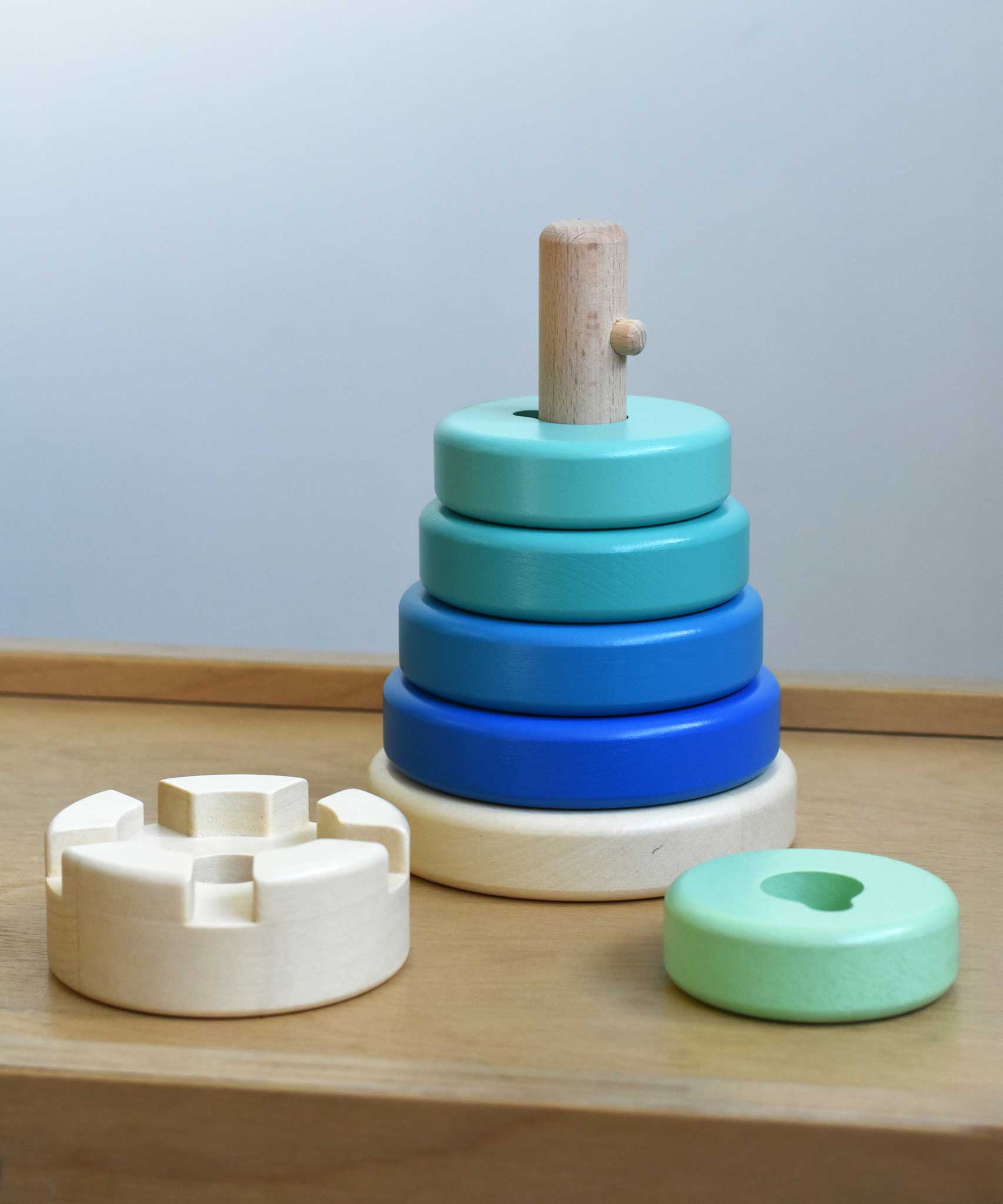 A blue coloured Bajo wooden rook stacking tower toy placed on a Miri slide. These heirloom quality toys by Bajo are part of a wide range of wooden toys available here at Babipur.