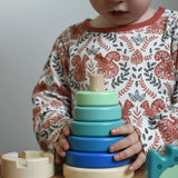 A child playing with a blue coloured Bajo wooden rook stacking tower toy. These heirloom quality toys by Bajo are part of a wide range of wooden toys available here at Babipur.