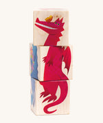 The Bajo Rotary Wooden Blocks Puzzle in a dragon design. The blocks are aligned to show a full dragon illustration