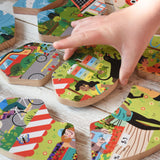A close up of a child's hand holding a piece of the Bajo save our planet puzzle.