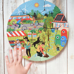 A child's hand hovering over the Bajo save our planet puzzle.