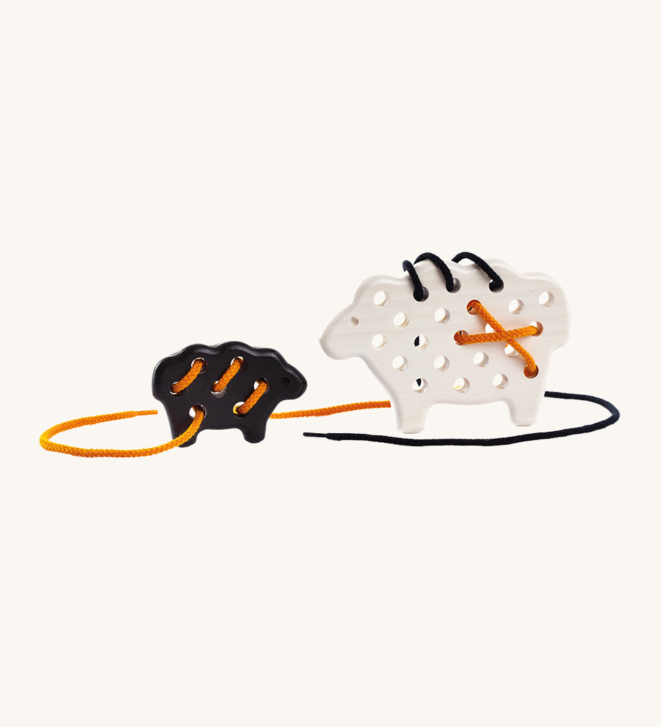 Bajo wooden Lacing Sheep Lamb toy. A white sheep and black lamb with black and orange laces. These heirloom quality toys by Bajo are part of a wide range of wooden toys available here at Babipur. 