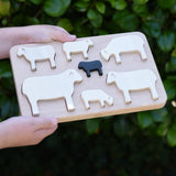 Bajo sheep puzzle shown in a child's hands.
