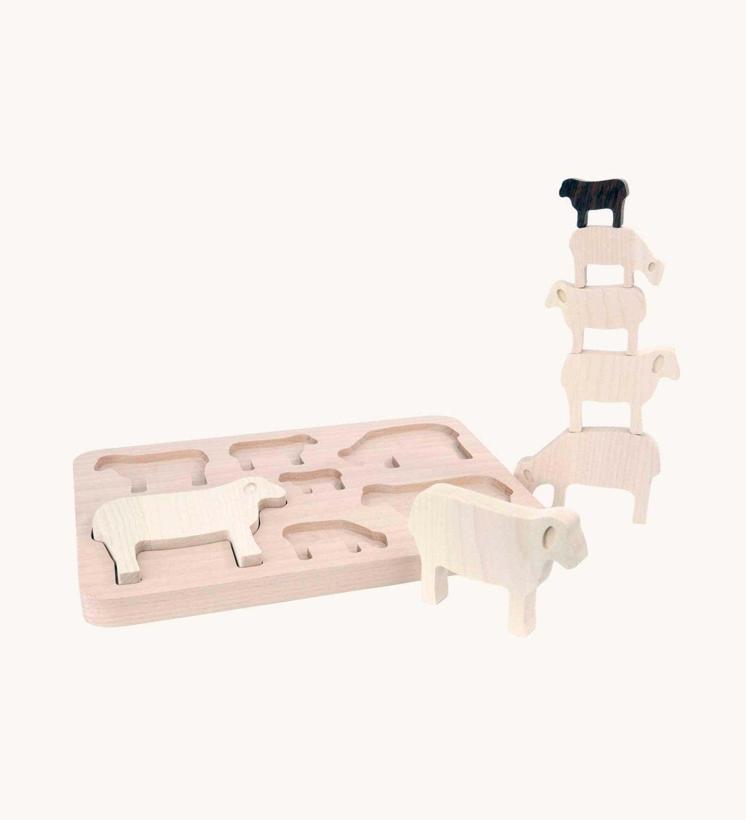 Bajo Sheep Puzzle. A wooden frame with 7 sheep shaped figures. Some of the figures are placed in the frame with others placed in a stack by the side of the frame.