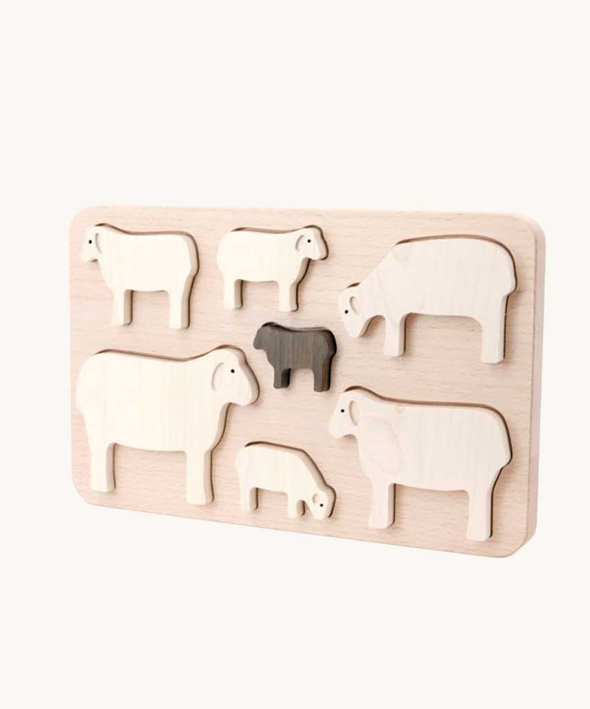 Bajo Sheep Puzzle. A wooden frame with 7 sheep shaped figures. 