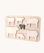 Bajo Sheep Puzzle. A wooden frame with 7 sheep shaped figures. 