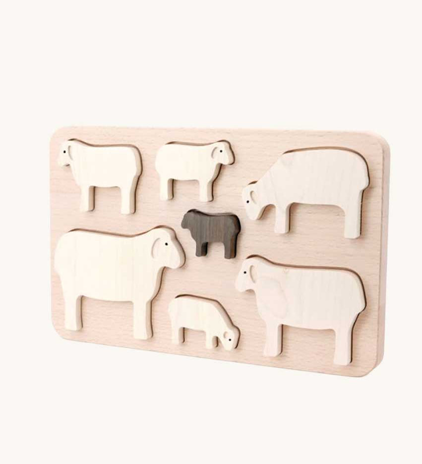 Bajo Sheep Puzzle. A wooden frame with 7 sheep shaped figures. 