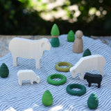 Sheep figures from the Bajo sheep puzzle used in a small world play scene with Grapat mandala pieces and rings as scenery. 