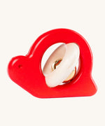 Bajo Snail Rattle baby toy. A red coloured Bajo snail baby toy. A red coloured snail with a bell detail.