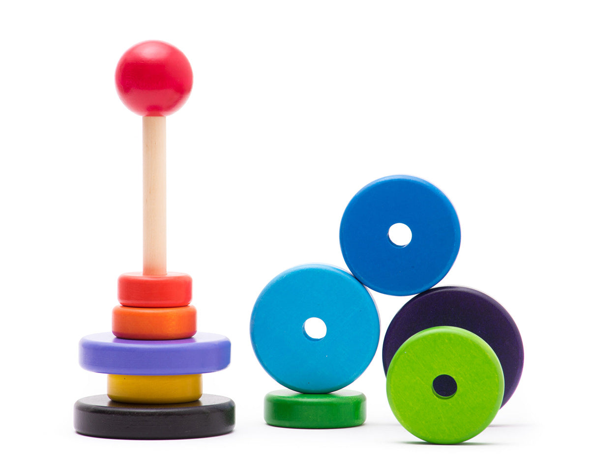 Bajo sustainable wooden stacker puzzle pieces scattered on a white background