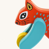 A close up of the Bajo x Tobe red wooden jumping squirrel toy available at Babipur. Showing the cute painted face and wheels on the front 