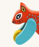 A close up of the Bajo x Tobe red wooden jumping squirrel toy available at Babipur. Showing the cute painted face and wheels on the front 