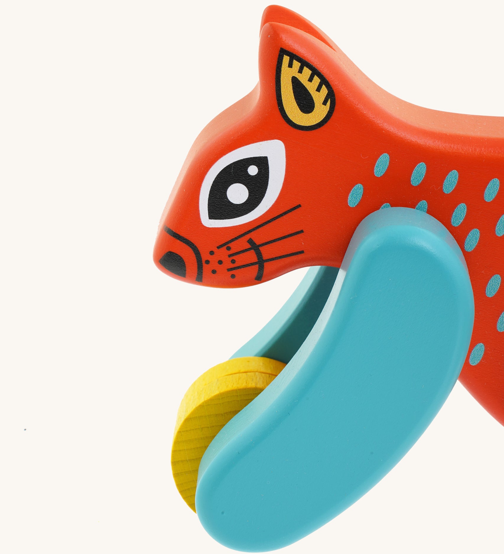 A close up of the Bajo x Tobe red wooden jumping squirrel toy available at Babipur. Showing the cute painted face and wheels on the front 