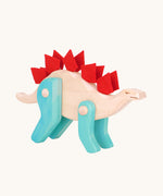 Tobe Extinct Animals Stegosaurus. A natural wooden body with blue coloured legs and red felt details along the back. These heirloom quality toys by Tobe Bajo are part of a wide range of wooden toys available here at Babipur. 