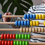 Close up of child playing with the Bajo 50 bead wide abacus in the Babipur playroom.