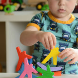 A child playing with the Bajo Acrobats balancing game. A set of 8 coloured wooden acrobat shaped figures. These heirloom quality toys by Bajo are part of a wide range of wooden toys available here at Babipur.