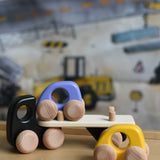A black coloured Bajo Auto Transporter. The wooden toy car transporter comes with two cars, one purple and one yellow. These heirloom quality toys by Bajo are part of a wide range of wooden toys available here at Babipur. 