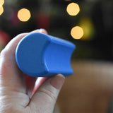 A close up of a blue moon shaped block from the Bajo Balance Scale wooden toy. A wooden base with a curved base with coloured wooden blocks that sit on top. These heirloom quality toys by Bajo are part of a wide range of wooden toys available here at Babipur.