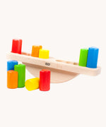 Bajo Balance Scale wooden toy. A wooden base with a curved base with coloured wooden blocks that sit on top. These heirloom quality toys by Bajo are part of a wide range of wooden toys available here at Babipur.