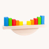 Bajo Balance Scale wooden toy. A wooden base with a curved base with coloured wooden blocks that sit on top. These heirloom quality toys by Bajo are part of a wide range of wooden toys available here at Babipur.