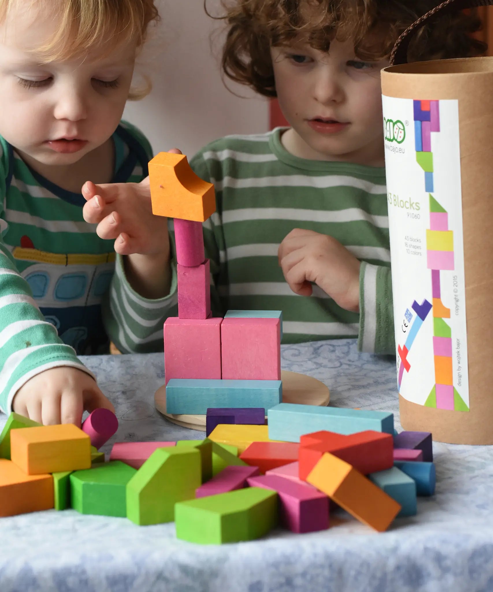 Bajo 43 wooden building blocks. 43 blocks, in 16 different shapes and 10 colours. Children stacking blocks.