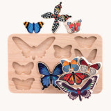 Bajo World Of Butterflies Sorter Puzzle. This puzzle has butterfly shaped pieces that are decorated on both sides that slot into the coordinating shapes on the base. The butterfly shaped figures have been taken out of the base and stacked on top of each other. These heirloom quality toys by Bajo are part of a wide range of wooden toys available here at Babipur.