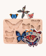 Bajo World Of Butterflies Sorter Puzzle. This puzzle has butterfly shaped pieces that are decorated on both sides that slot into the coordinating shapes on the base. The butterfly shaped figures have been taken out of the base and stacked on top of each other. These heirloom quality toys by Bajo are part of a wide range of wooden toys available here at Babipur.