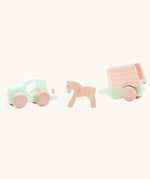 Bajo mint green 4x4 car and horse trailer wooden toy with the car separated from the trailer with the horse shown inbetween them.