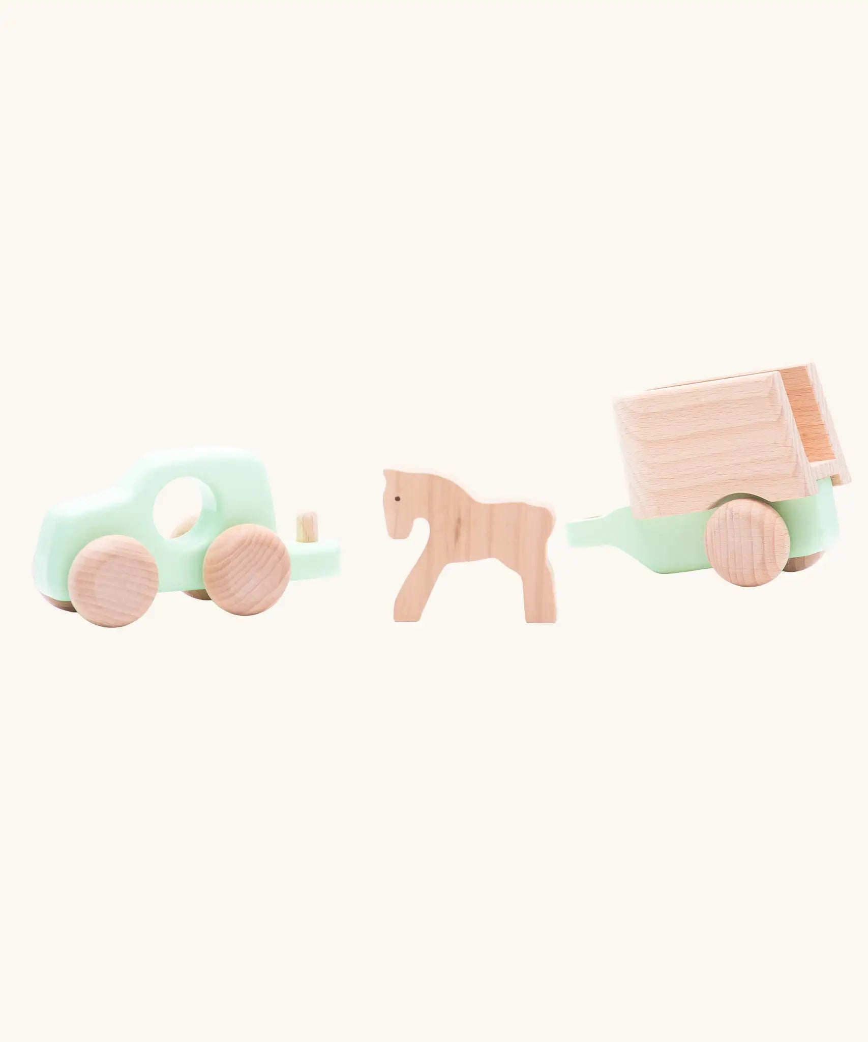 Bajo mint green 4x4 car and horse trailer wooden toy with the car separated from the trailer with the horse shown inbetween them.
