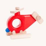 Bajo Red Fire Engine Helicopter wooden toy. The red coloured wooden helicopter has natural propellers and stand and a blue lamp details on the front. These heirloom quality toys by Bajo are part of a wide range of wooden toys available here at Babipur. 