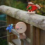 The Bajo Red Fire Engine Helicopter wooden toy used in a small world play scene with Kraul passenger felt dolls and the Kraul cable cars with basket kit. The red coloured wooden helicopter has natural propellers and stand and a blue lamp details on the front. These heirloom quality toys by Bajo are part of a wide range of wooden toys available here at Babipur. 