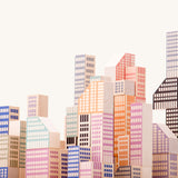 A close up of the Bajo Manhattan city Blocks wooden toy blocks on a wooden base.