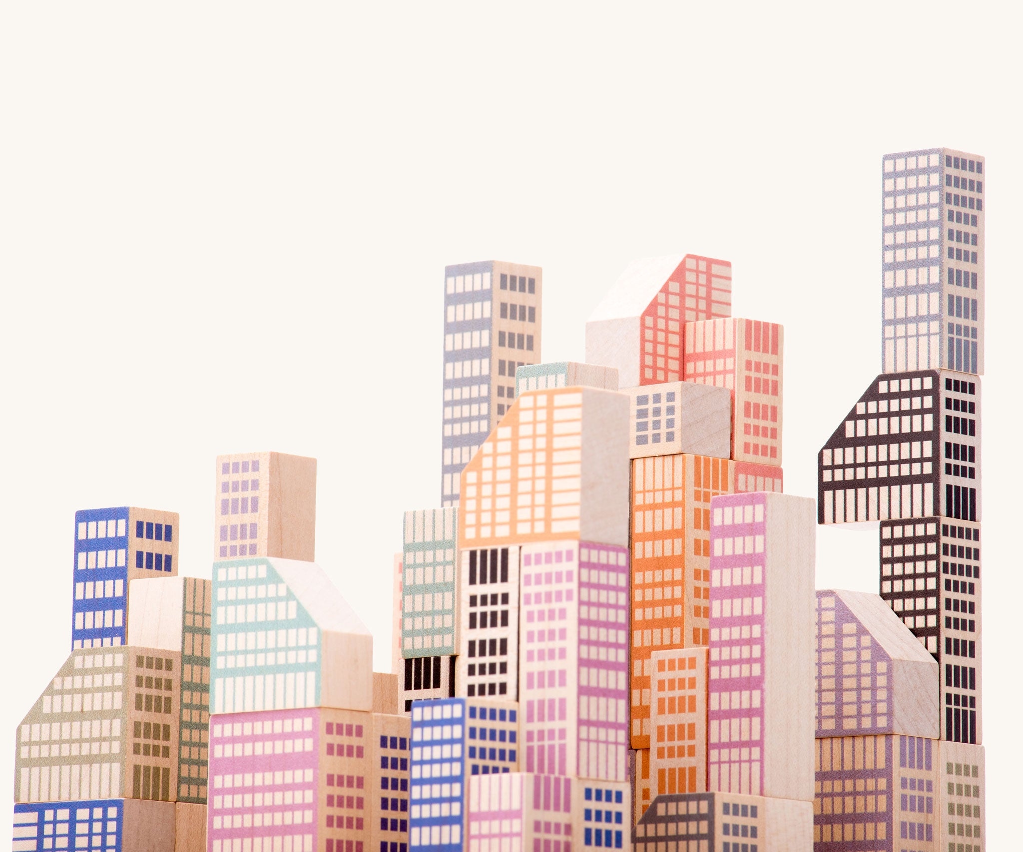 A close up of the Bajo Manhattan city Blocks wooden toy blocks on a wooden base.