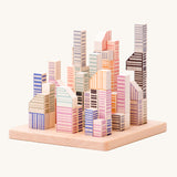 Bajo Manhattan city Blocks wooden toy blocks on a wooden base.