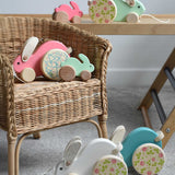 The Bajo big and small rabbits shown on and next to a chil'ds chair and Miri slide. These heirloom quality toys by Bajo are part of a wide range of wooden toys available here at Babipur.