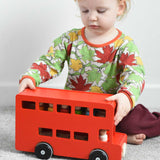 A child playing with the Bajo London bus wooden toy. These heirloom quality toys by Bajo are part of a wide range of wooden toys available here at Babipur