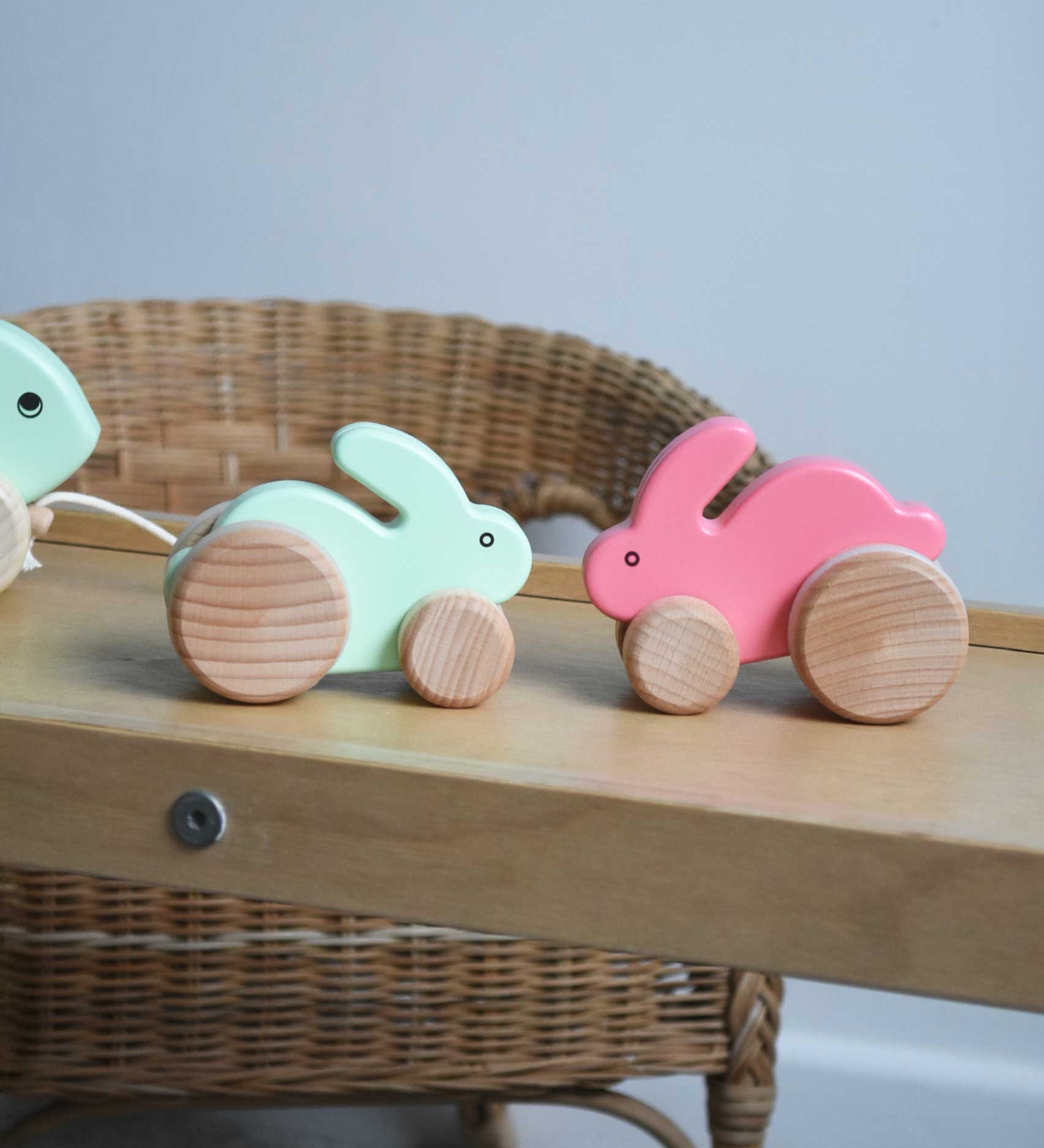 A mint and pink coloured small Bajo rabbit toy placed on a Triclimb Miri slide. These heirloom quality toys by Bajo are part of a wide range of wooden toys available here at Babipur.