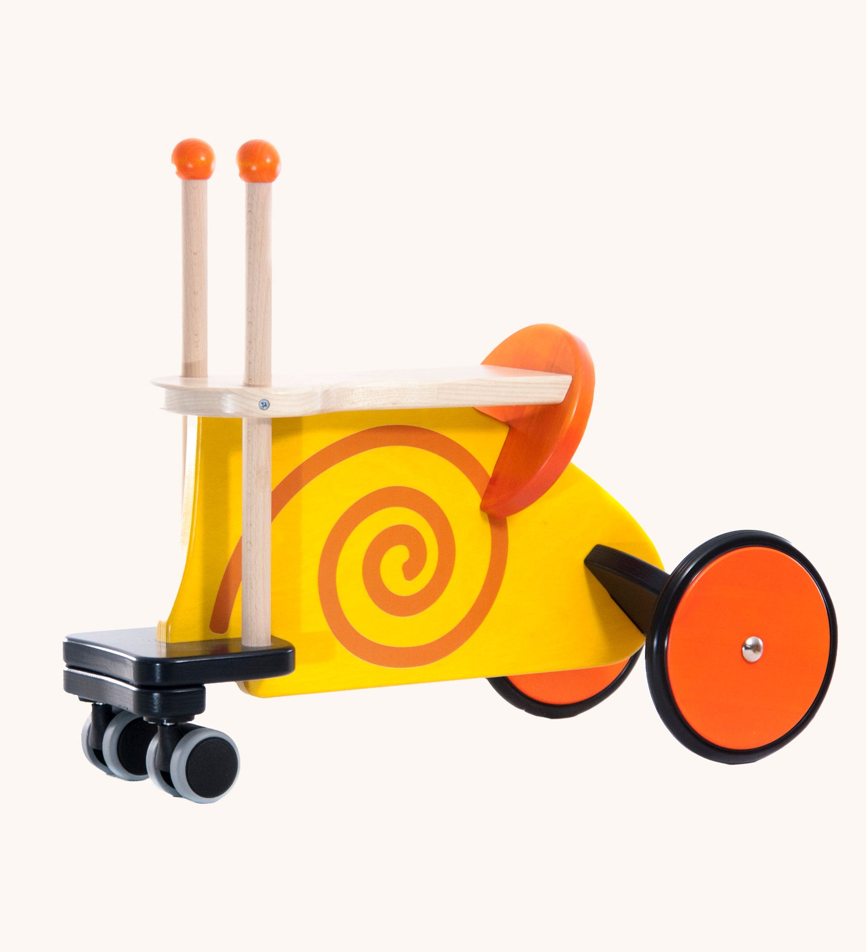 Bajo toys wooden snail ride on toy. A yellow coloured snail with orange swirl details and features and orange wheels. These heirloom quality toys by Bajo are part of a wide range of wooden toys available here at Babipur. 