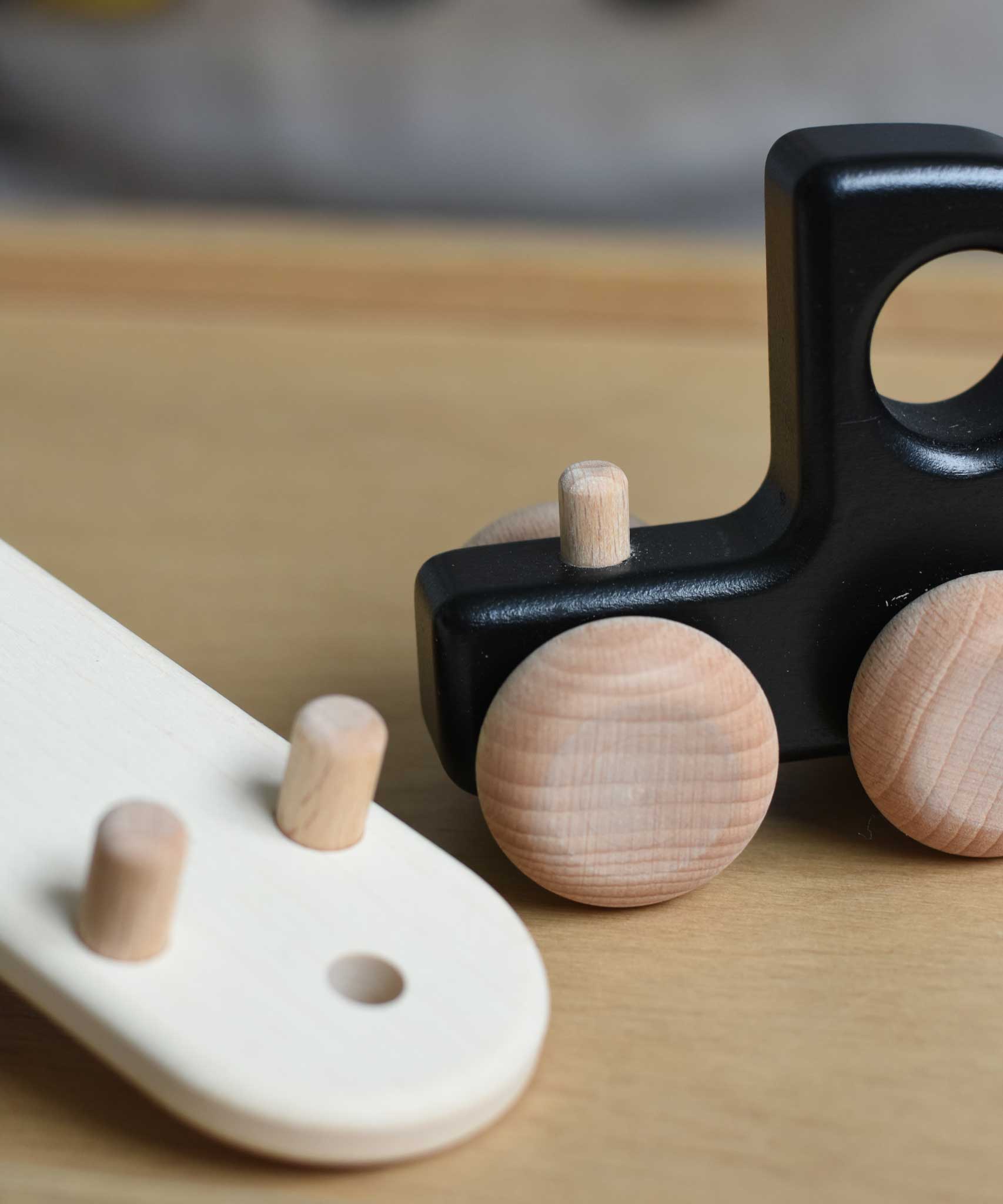 A close up of the trailer attachment hitch on the black Bajo Auto Transporter with the trailer detached. These heirloom quality toys by Bajo are part of a wide range of wooden toys available here at Babipur. 