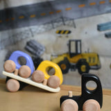 A black Bajo auto transporter shown with the trailer detached from the cab.  These heirloom quality toys by Bajo are part of a wide range of wooden toys available here at Babipur. 