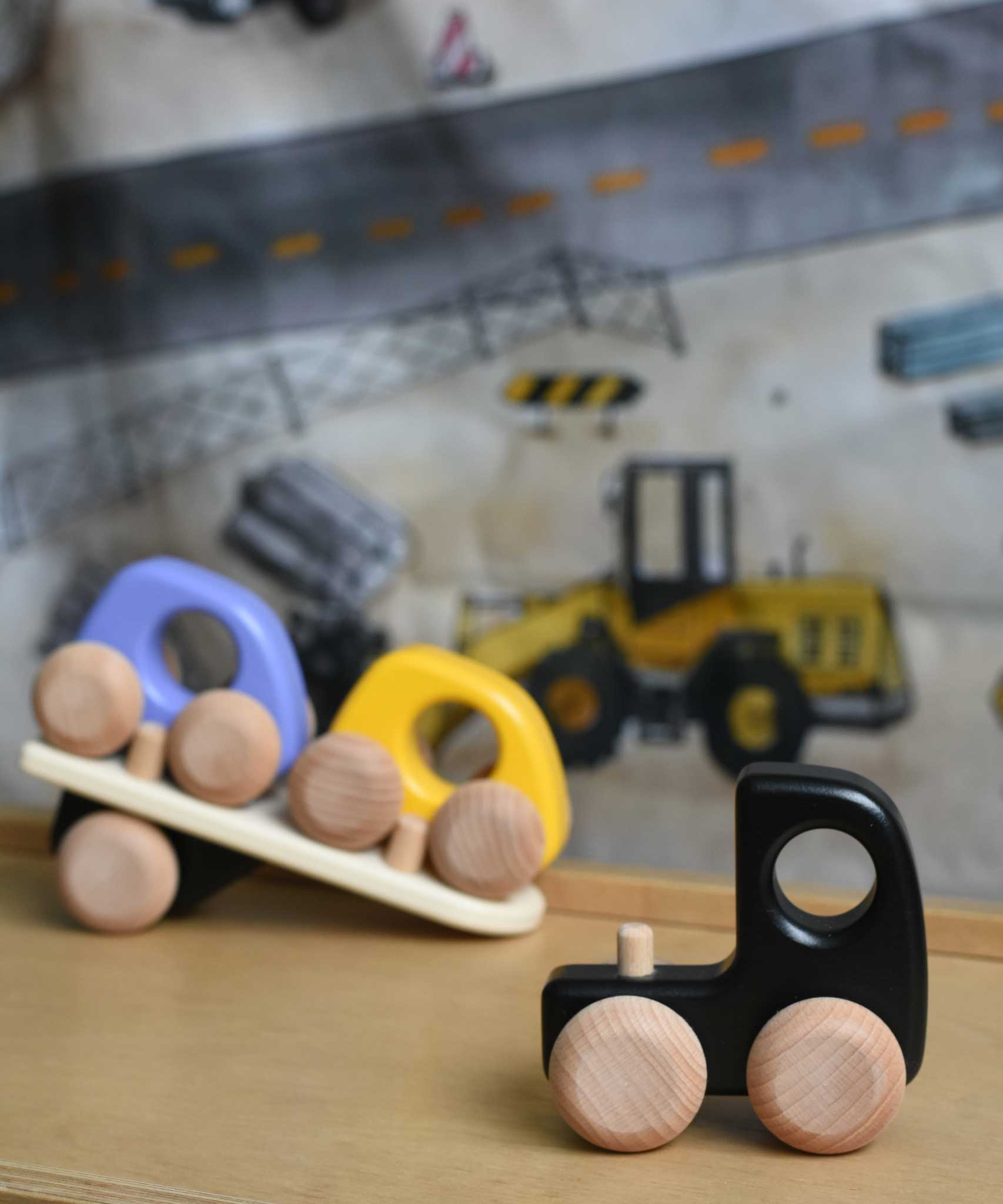 A black Bajo auto transporter shown with the trailer detached from the cab.  These heirloom quality toys by Bajo are part of a wide range of wooden toys available here at Babipur. 