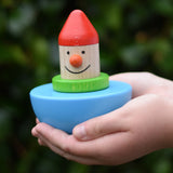 Bajo roly poly wobbling dwarf wooden baby toy in a child's hands