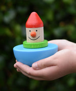 Bajo roly poly wobbling dwarf wooden baby toy in a child's hands